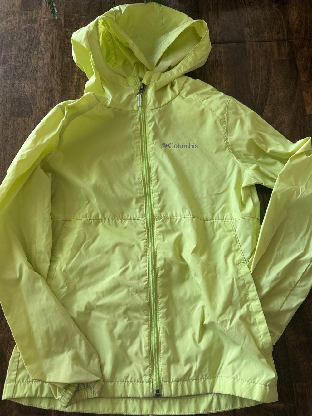 Columbia Kids' Lightweight Hooded rain Jacket in light green.